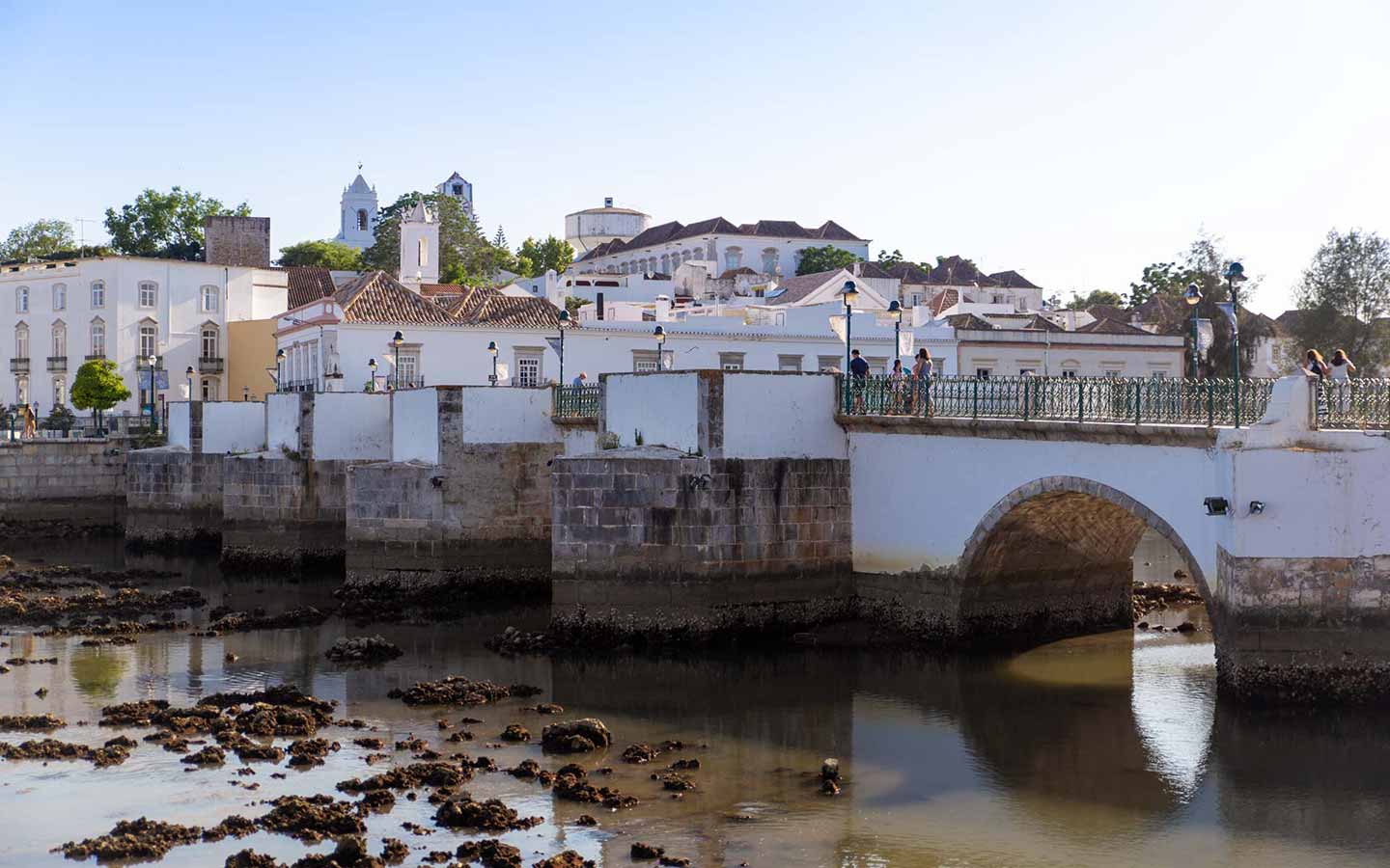 Eastern Algarve travel guide: historic Tavira bridge and whitewashed townscape in Portugal